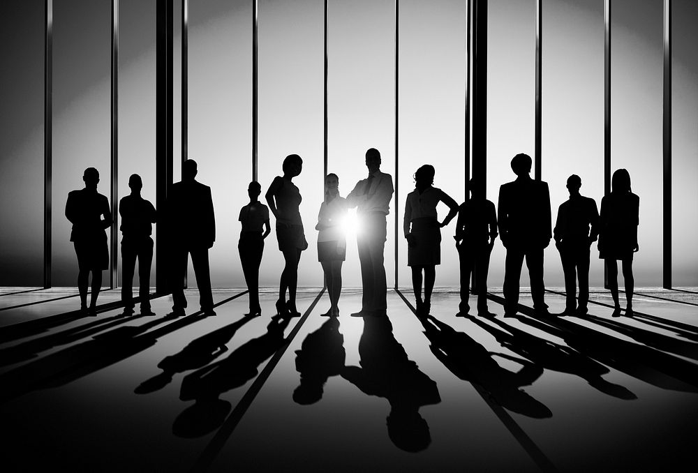 Confident silhouette of business people posing for the camera indoors.