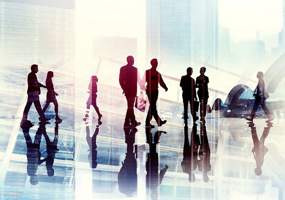 Silhouettes of Business People Walking inside the Office
