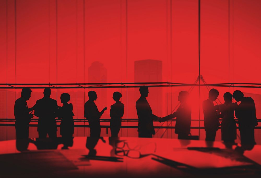 Silhouettes of Business People Meeting Handshake Concept