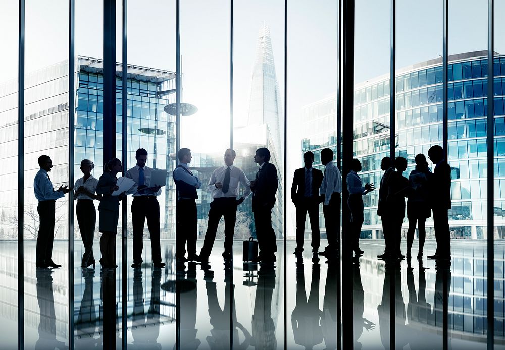 Silhouettes of Business People Working and Cityscape