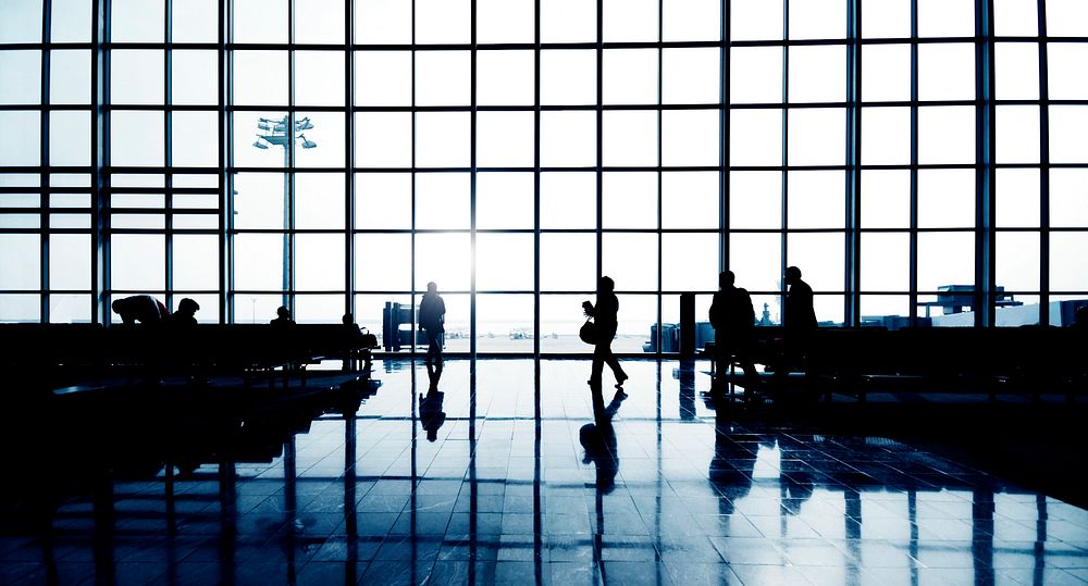Silhouettes of people walking at the airport