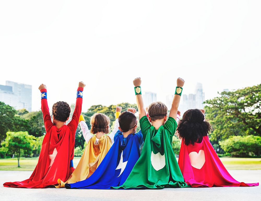 Superhero kids with their hands up