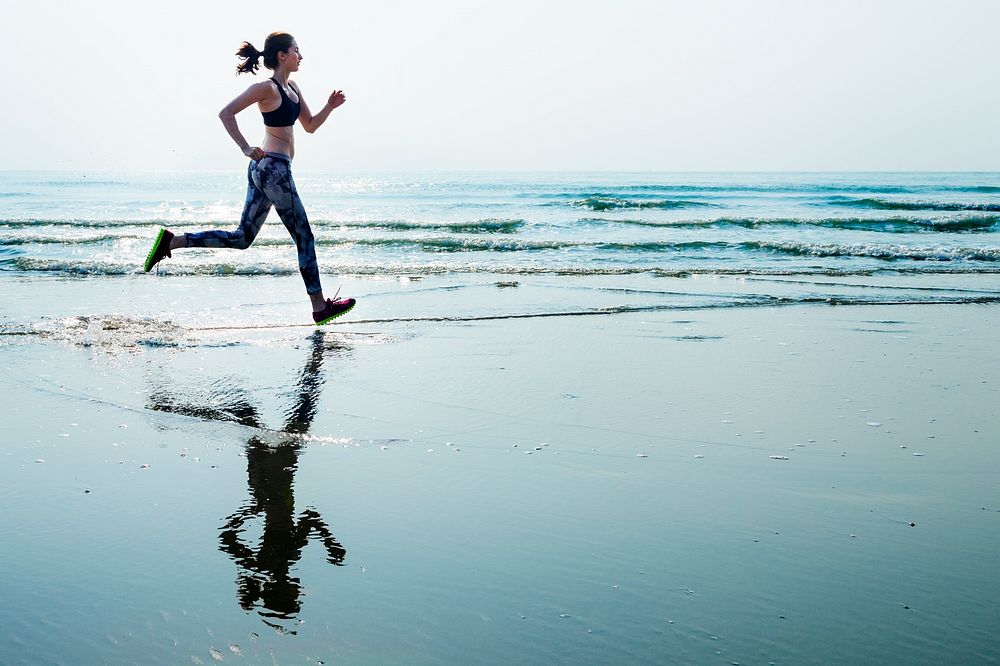 A woman is running at the beach