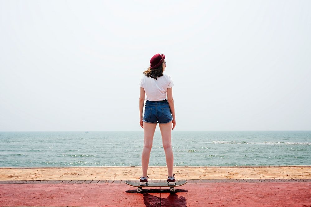 Girl on a skateboard by the bay