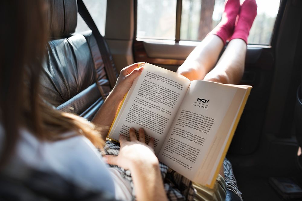 Girl Reading Book Road Trip Concept