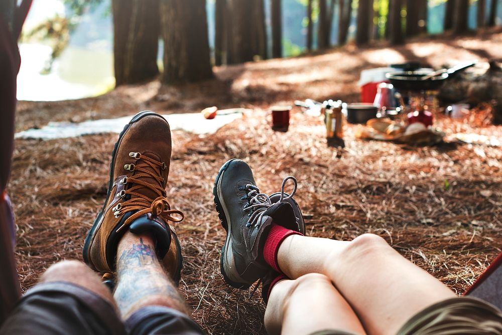 Couple Legs Relaxing Camping Outdoors Concept