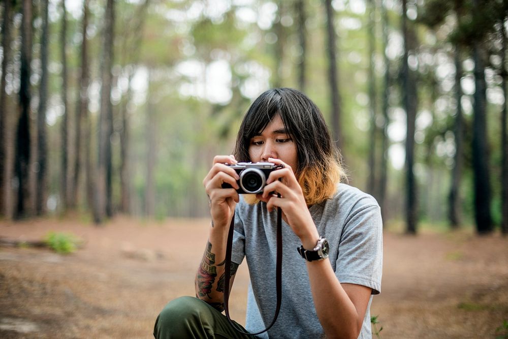 Asian Photographer Taking Pictures Outdoors Concept