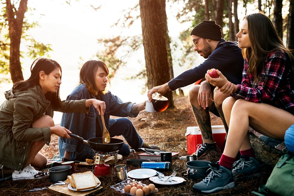 Friends making breakfast at a campsite