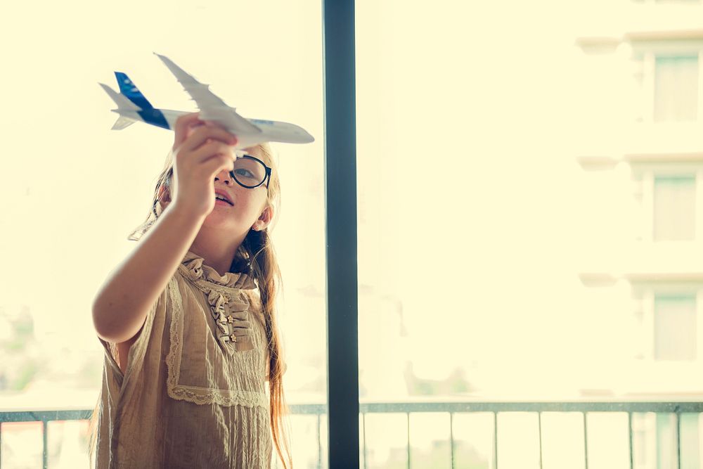 Girl Playing Plane Toy Concept