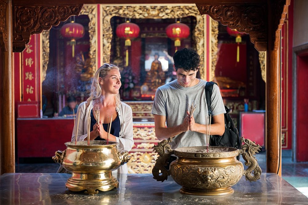 Caucasian couple is praying in the temple