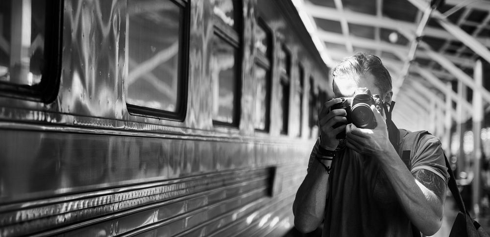 Caucasian photographer at the train station