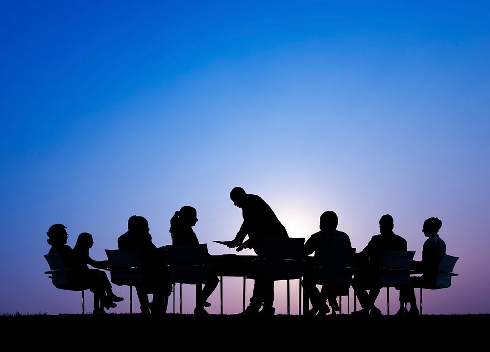 Silhouettes of Business People in a Meeting Outdoors