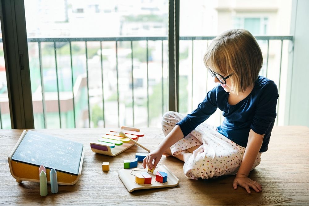 Girl playing with wooden toys