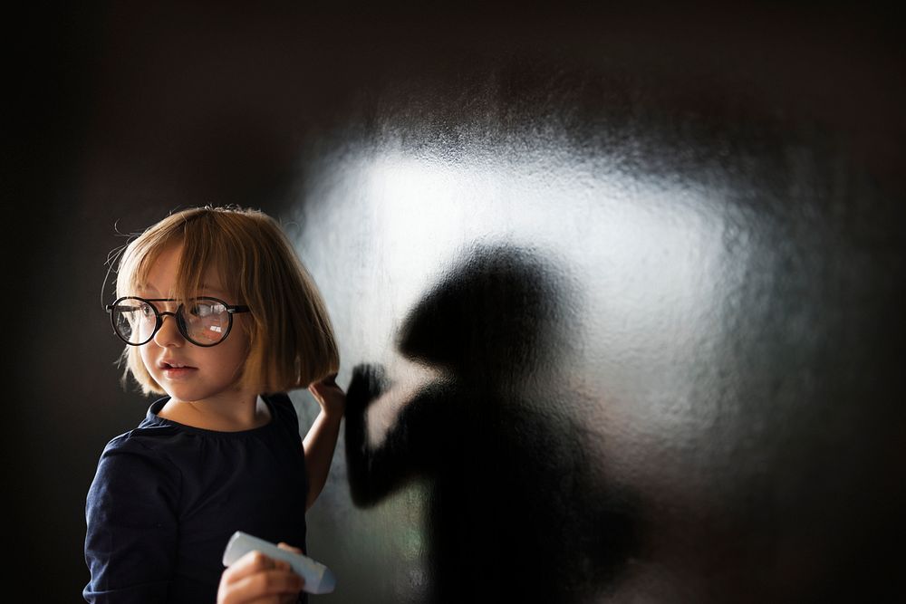 Little Girl Writing Blackboard Concept