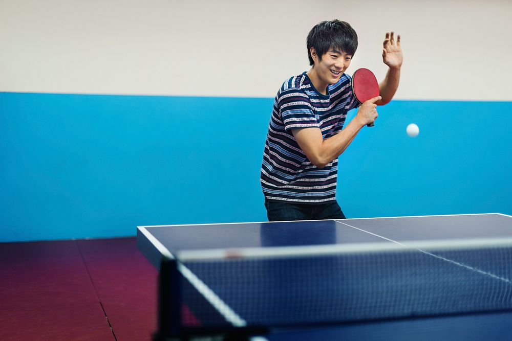 Asian man playing table tennis