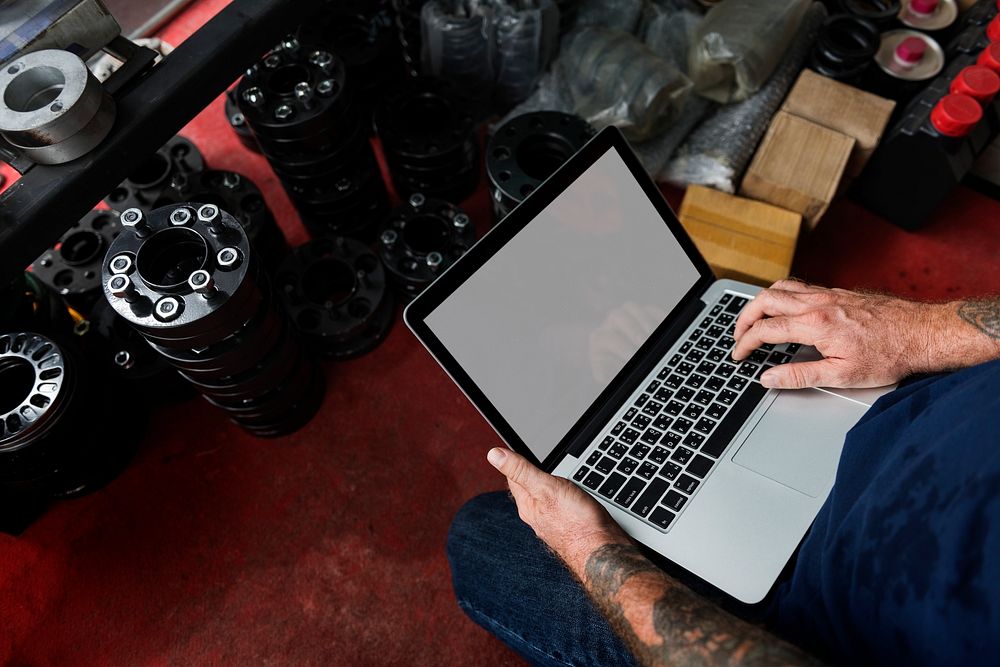 A mechanic working with his laptop