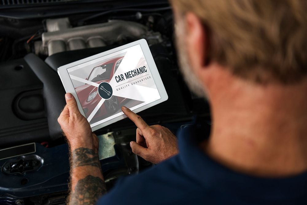 Auto Repair Shop Owner Checking Tablet Concept