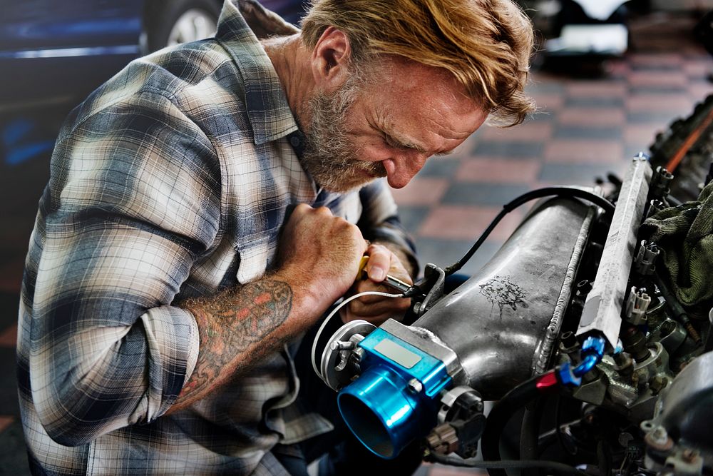 A mechanic fixing an engine