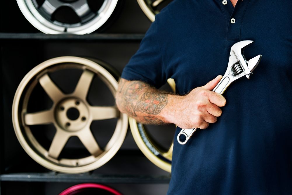 A mechanic holding a wrench