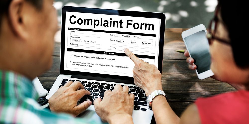 Senior couple filling out an online complaint form