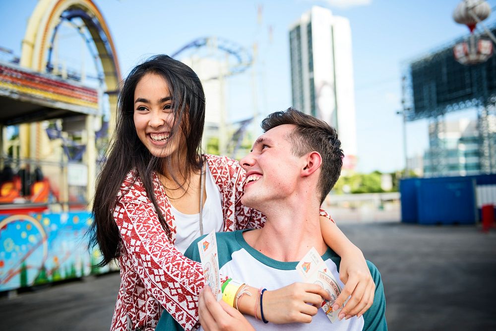 Young couple having fun together at an amusement park