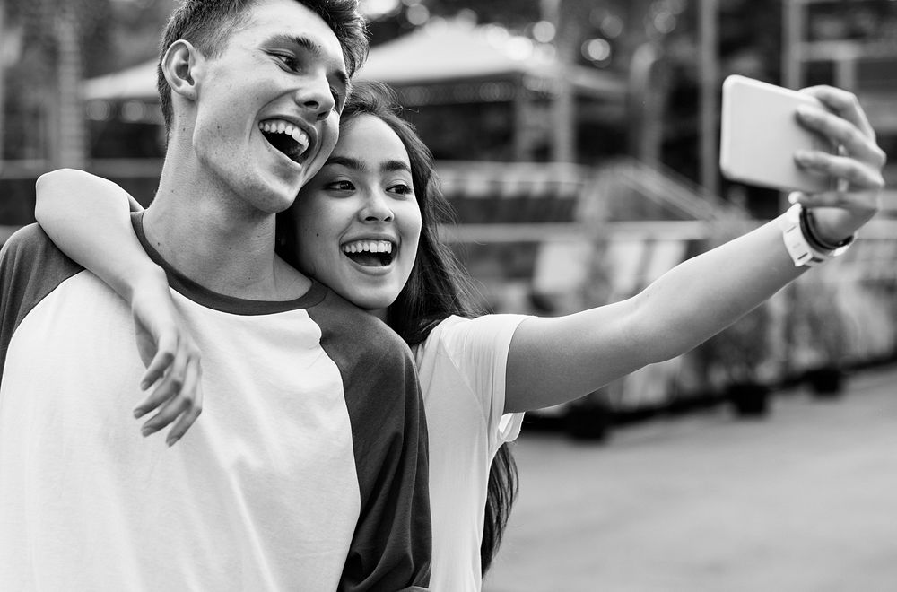 Teenage Couple Amusement Park Selfie Concept