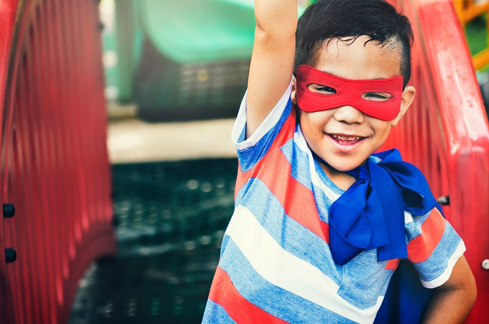 Superhero boy playing at a playground