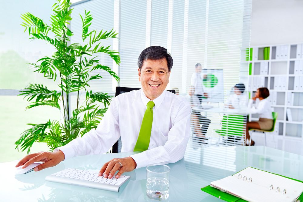 Senior businessman in a green office