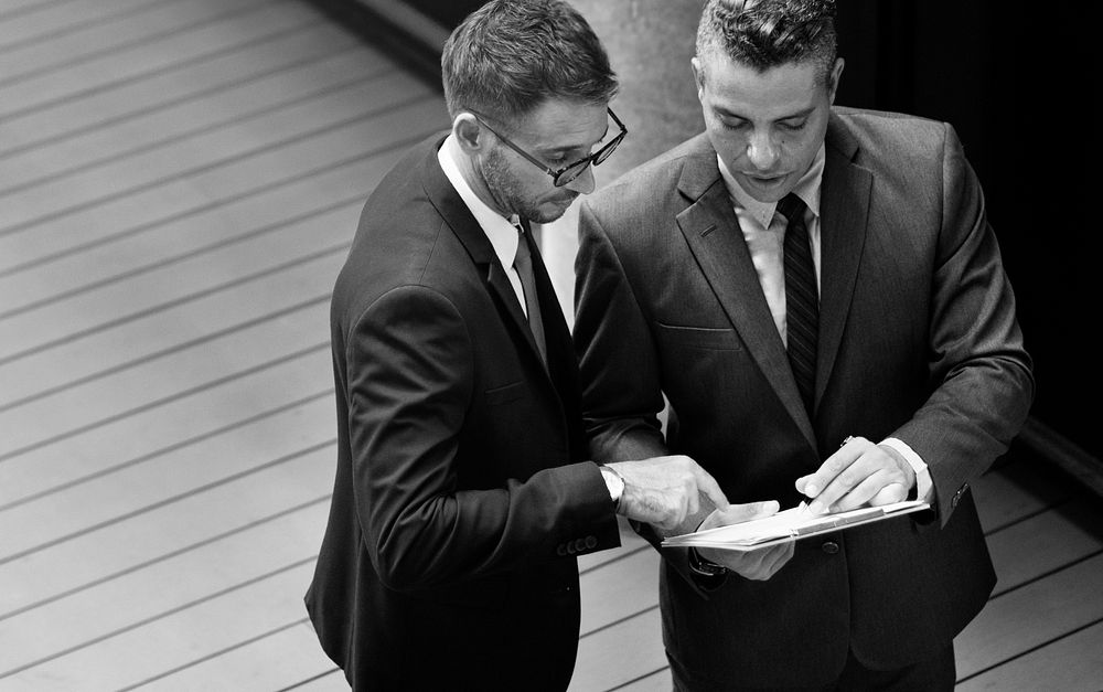 Businessmen talking together grayscale