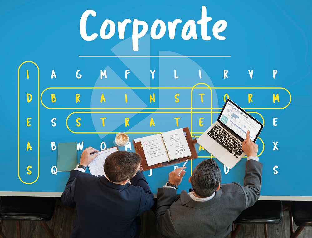 Business word puzzle graphic on the table with two businessmen