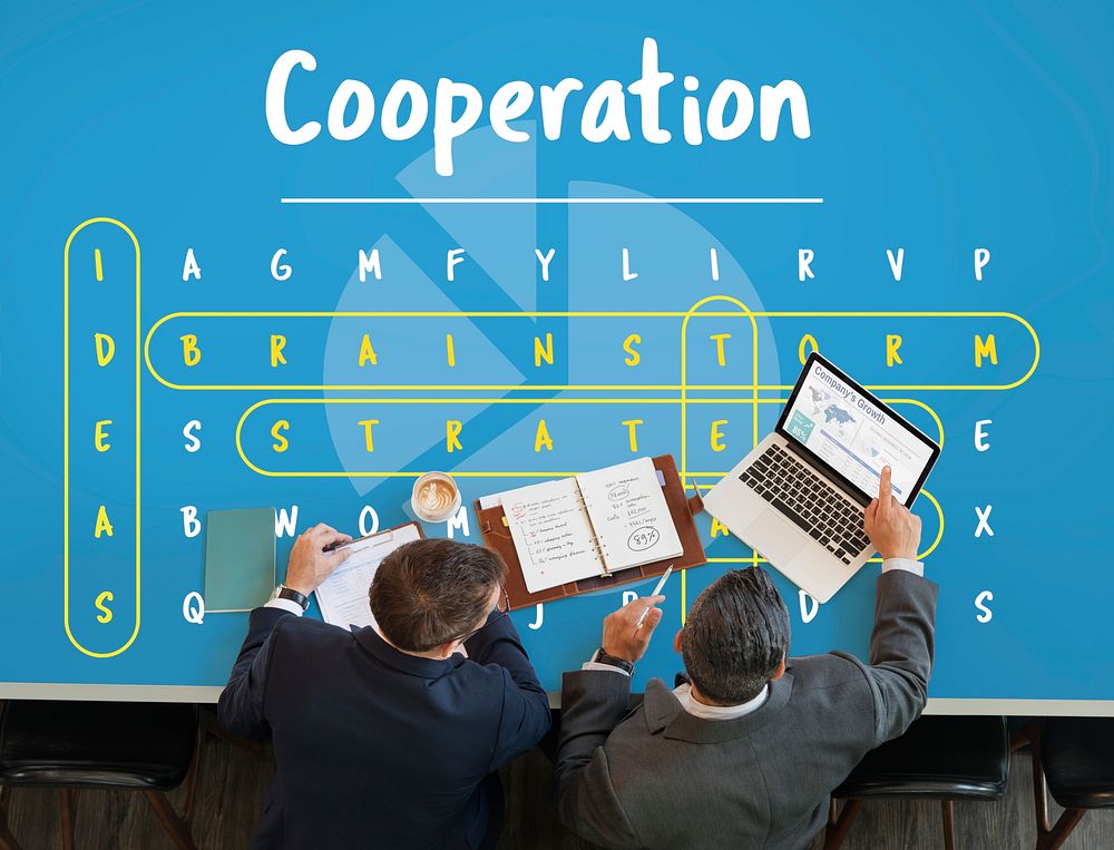 Business word puzzle graphic on the table with two businessmen