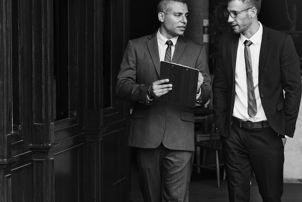 Businessmen Discussion Standing Clipboard Concept