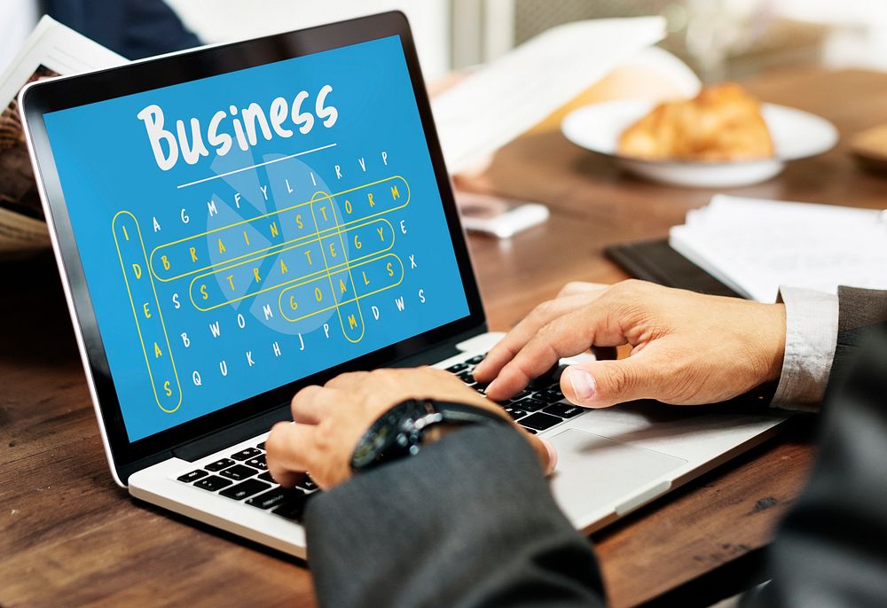 Business word puzzle with hands typing