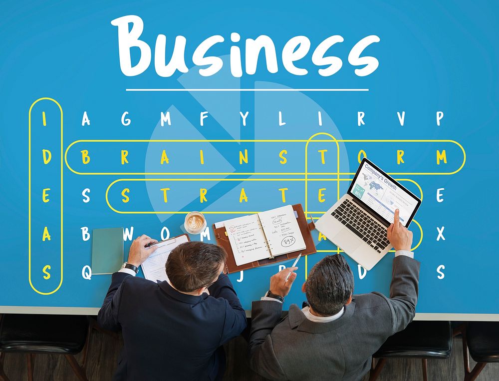 Business word puzzle on the table with two businessmen