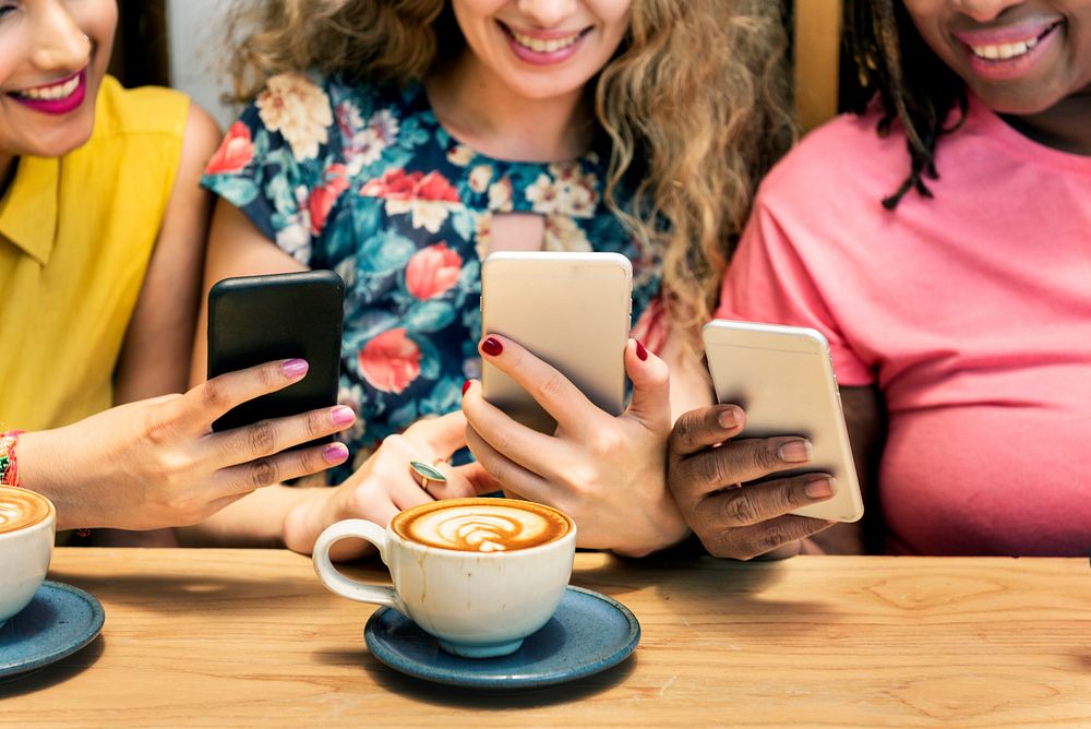 Group of Women Drinking Coffee Using Smart Phone Concept