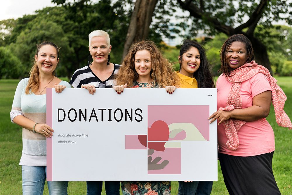 Group of women holding banner of charity donations campaign