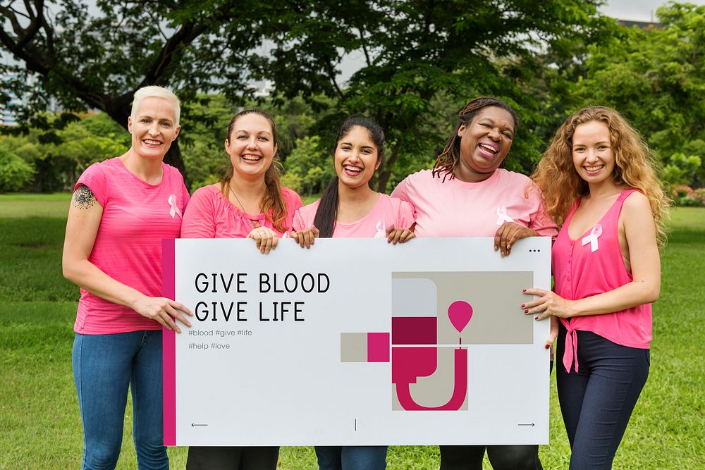 Group of women holding banner of blood donation campaign