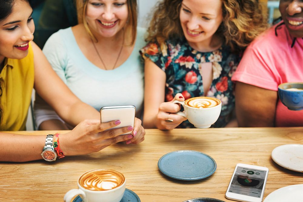 Group of Women Drinking Coffee Using Smart Phone Concept