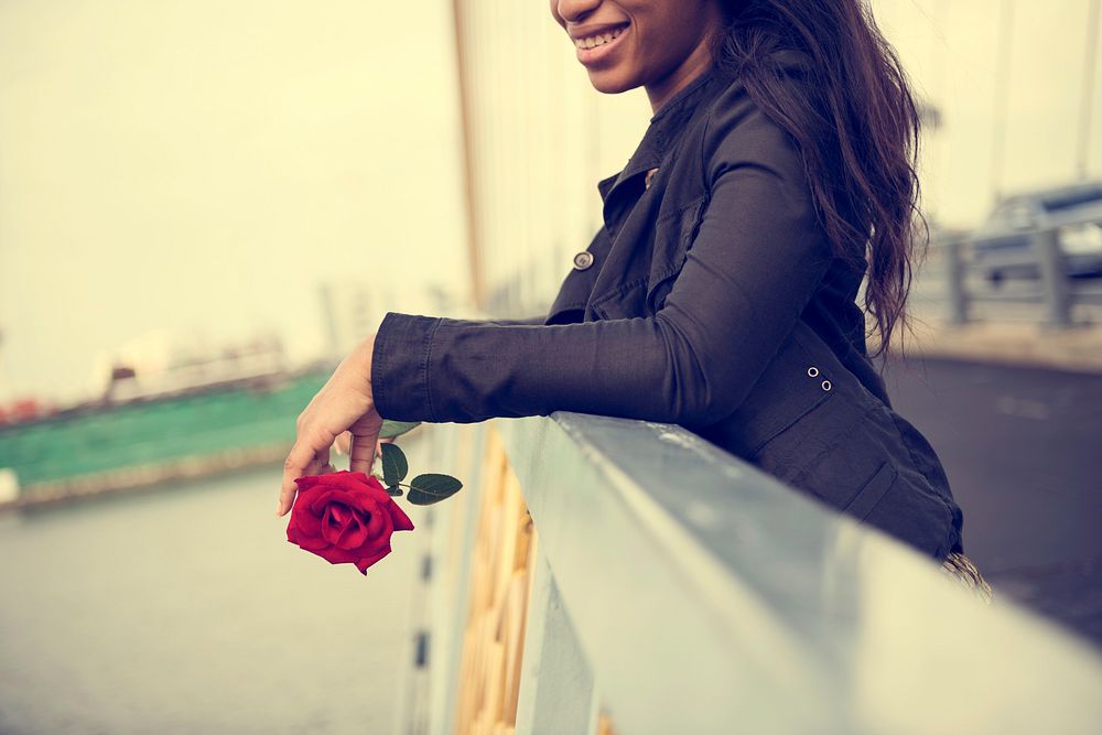African American woman with red rose