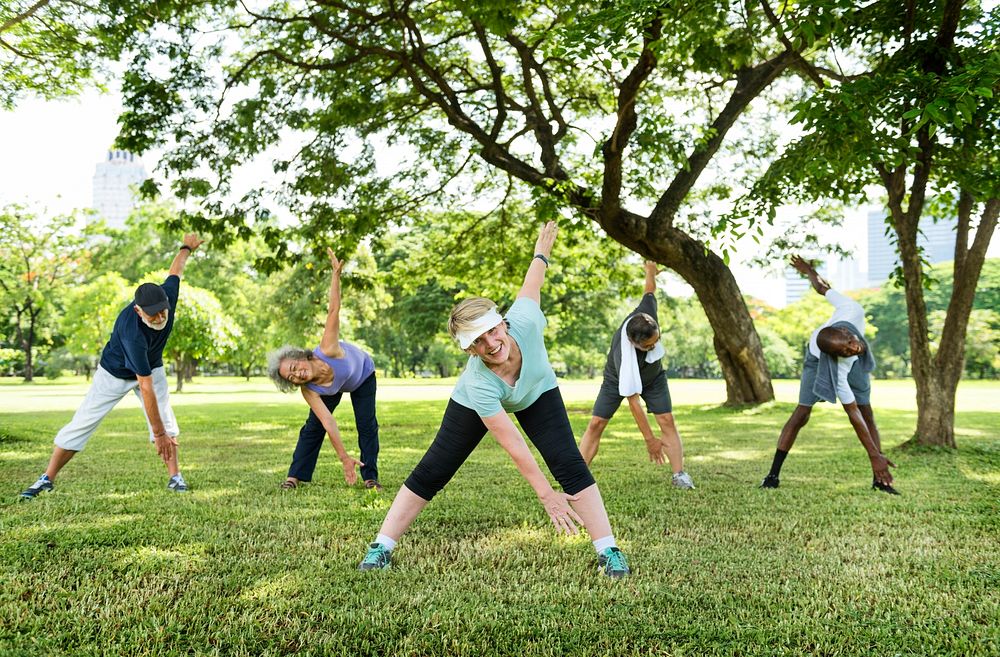 Group of senior friends stretching together in a park