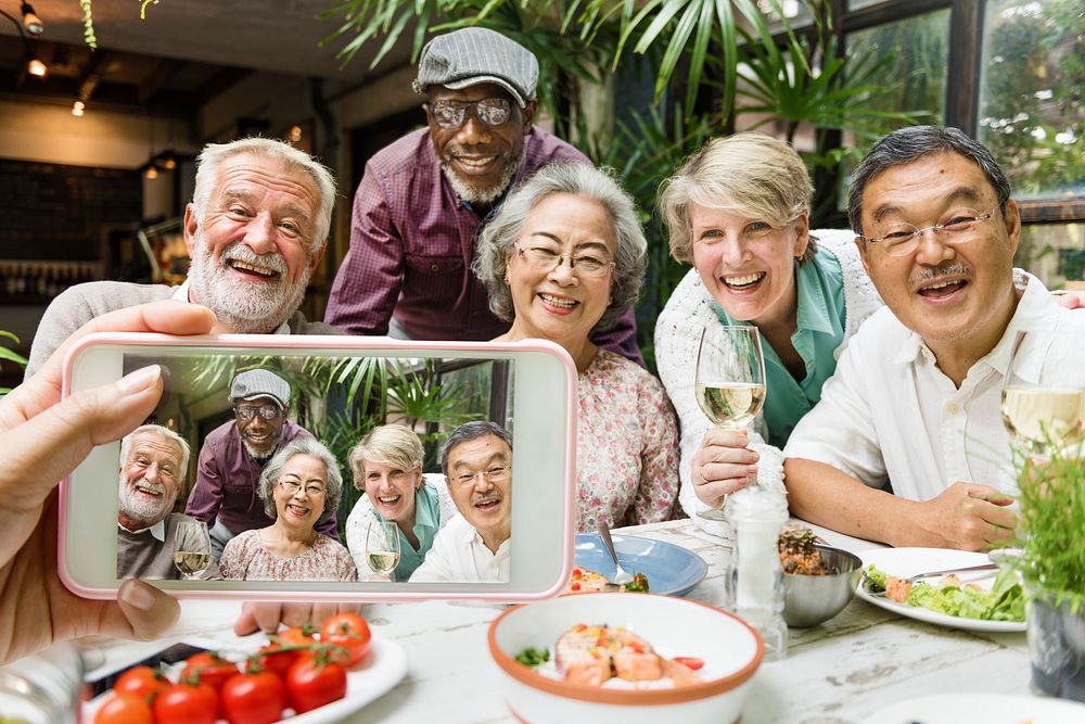 Group of old people having dinner taking a photo