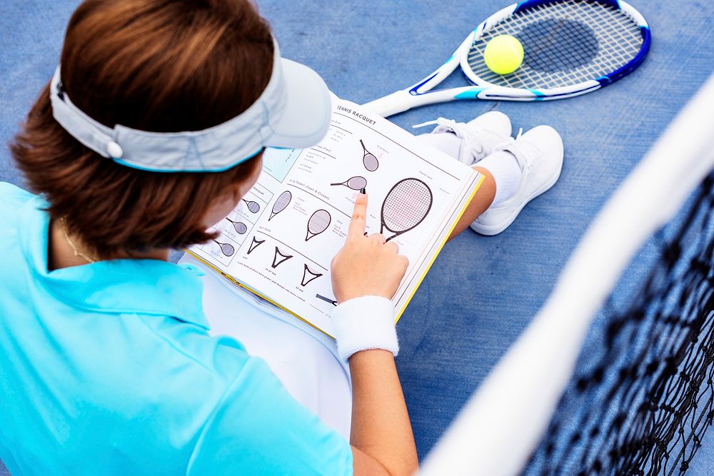 Tennis player reading a manual