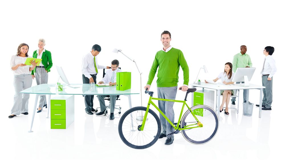 Businessman with a bicycle in a green office