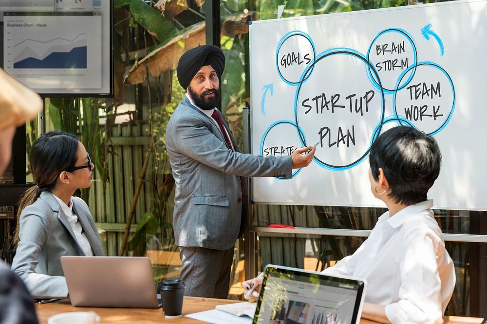 Business man in a turban doing a presentation