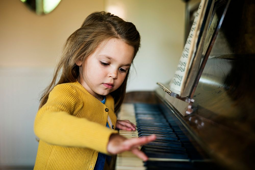 Adorable Cute Girl Playing Piano Concept