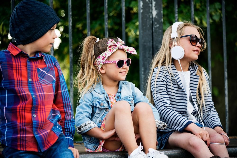 Fashionista kids sitting at a park