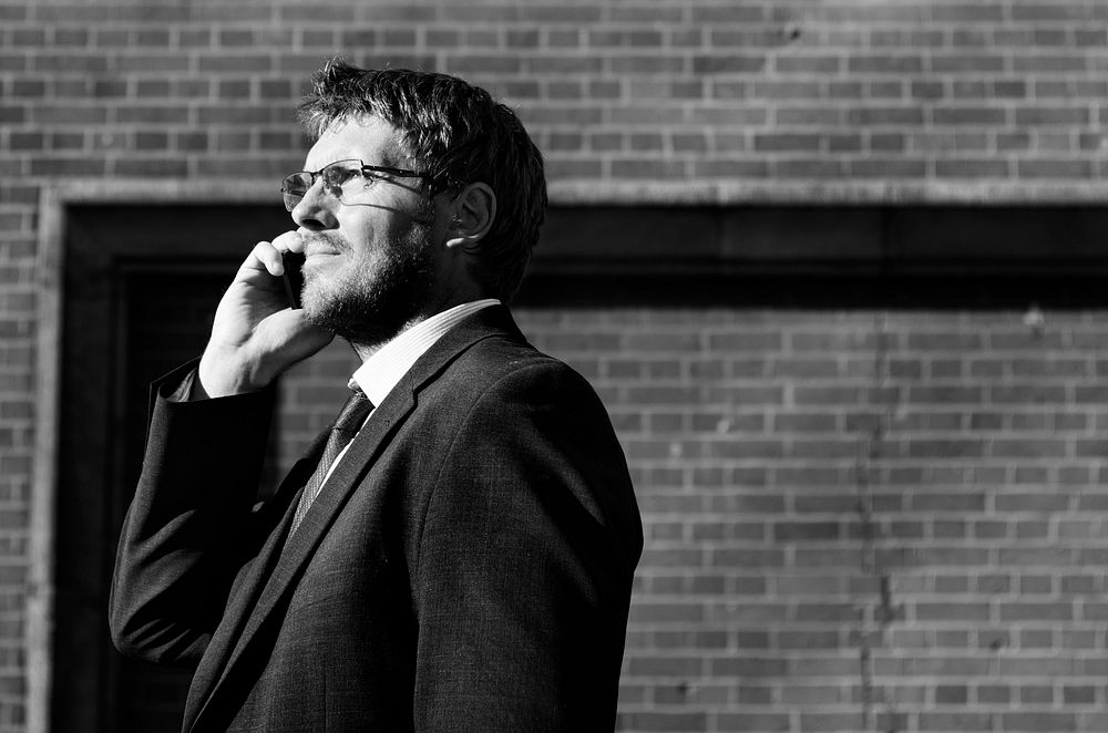 Black and white image of a businessman on the phone