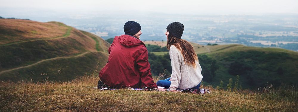Couple sitting on hill