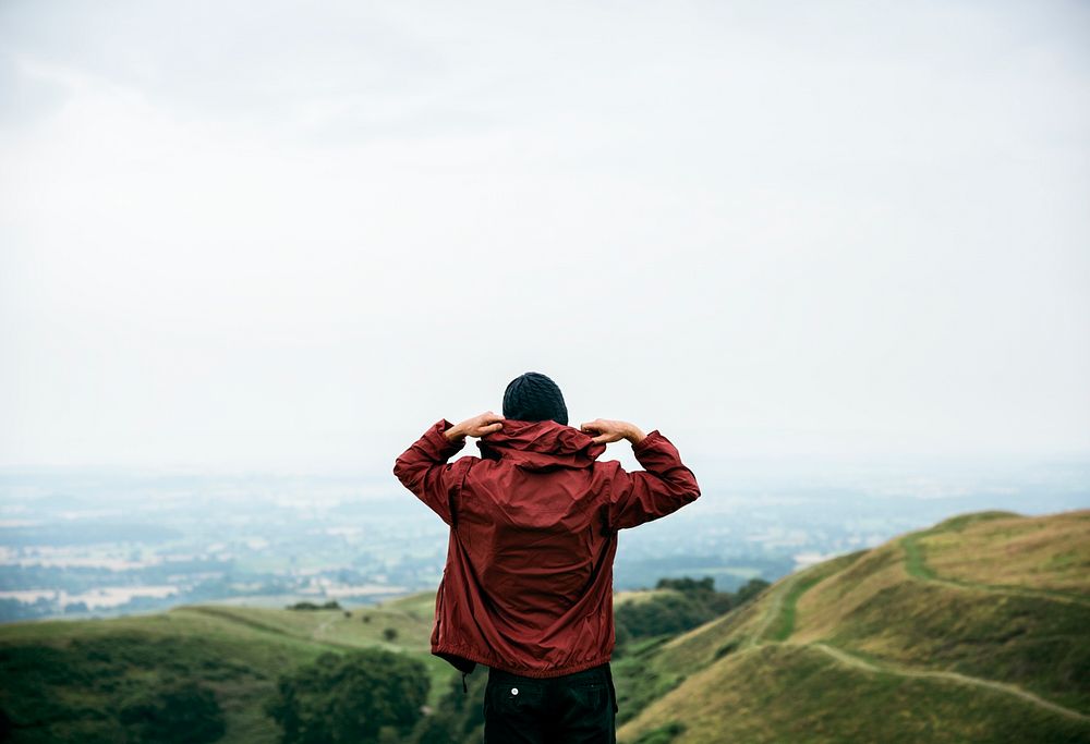 Rear view of man in hoodie jacket with nature landscape