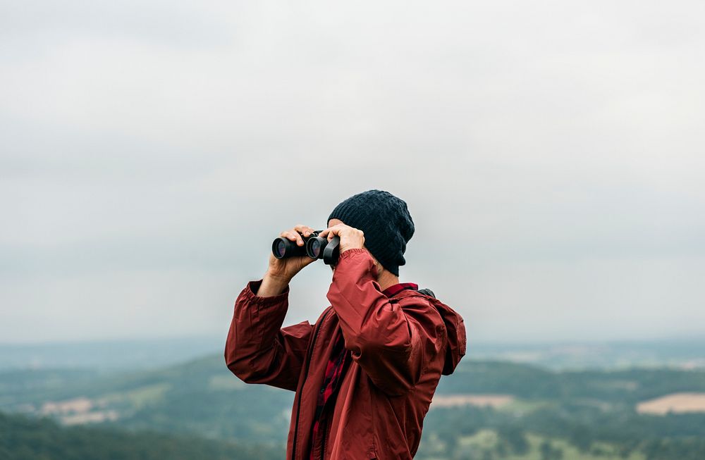 Side view of man using binocular